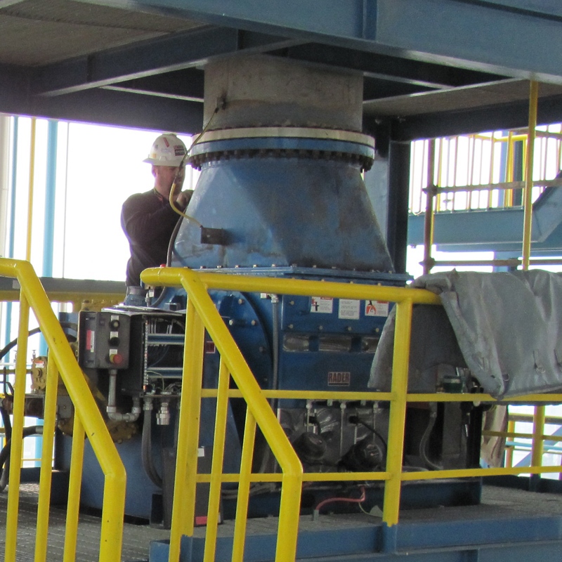 Jeffrey Rader® EDK Rotary Feeder/Delumper installed in an industrial processing facility with overhead inlet connection, operator access platform, and integrated control components.