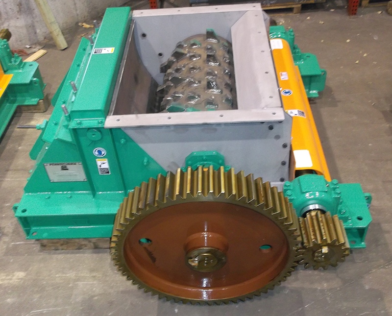 Pennsylvania Crusher single roll crusher with exposed crushing roll, gear drive components, and heavy-duty fabricated housing for primary material reduction applications.