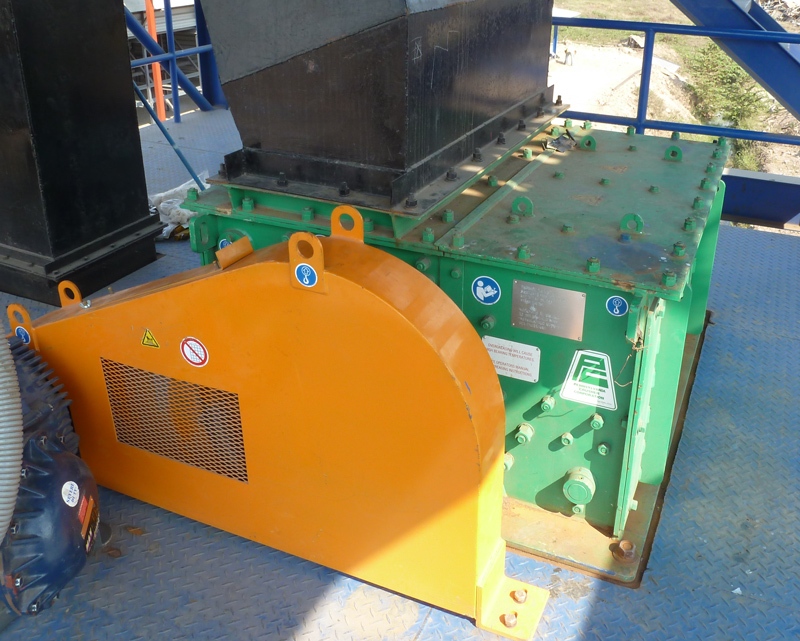 Pennsylvania Crusher TKK Granulator installed in an industrial processing facility with protective drive guard and feed chute for continuous material reduction operations.